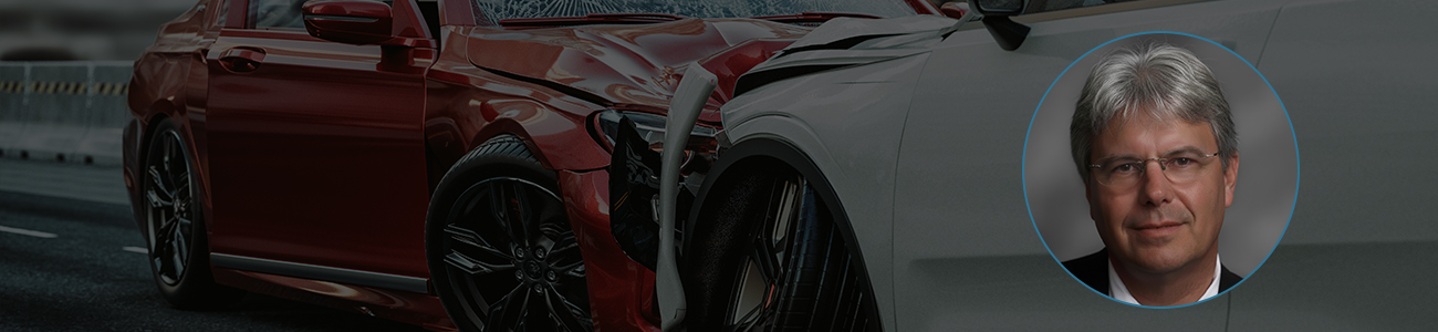 Attorney W.F. ‘Casey’ Ebsary Jr., with a damaged car in the background